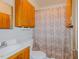 Functional bathroom featuring classic fixtures and cabinetry, toilet, sink and shower curtain at 2021 Bundy Ave, Durham, NC 27704