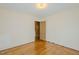Bright bedroom with hardwood floors, fresh paint, and doorway leading to another room at 2021 Bundy Ave, Durham, NC 27704