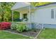 Inviting covered front porch with chairs and blooming shrubbery landscaping at 2021 Bundy Ave, Durham, NC 27704