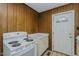 Cozy kitchen featuring a white stove, matching cabinetry, and an exterior access door at 2021 Bundy Ave, Durham, NC 27704