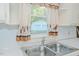 Bright kitchen sink area with stainless steel sink and a window view of the detached garage at 2021 Bundy Ave, Durham, NC 27704