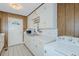 Kitchen area with classic white cabinets and appliances, plus a washing machine at 2021 Bundy Ave, Durham, NC 27704