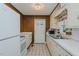 Functional kitchen with white appliances, wood-paneled walls, and ample counter space at 2021 Bundy Ave, Durham, NC 27704
