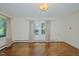 This bright living room is complete with hardwood floors and large, light-filled windows at 2021 Bundy Ave, Durham, NC 27704