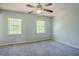 Bedroom with ceiling fan and carpeted floors with two windows at 2032 Lime St, Durham, NC 27704