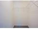 A simple closet with carpet and shelving, ready for your storage needs at 2032 Lime St, Durham, NC 27704
