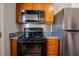 Kitchen with stainless steel appliances, wood cabinets, tile backsplash and gray countertop at 2032 Lime St, Durham, NC 27704