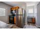 Kitchen area showcasing stainless steel refrigerator and oak cabinets at 2032 Lime St, Durham, NC 27704
