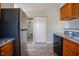 Open kitchen featuring stainless steel refrigerator and wood cabinets at 2032 Lime St, Durham, NC 27704
