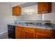 The kitchen features wood cabinets, stainless steel appliances, and a sink with a gray countertop at 2032 Lime St, Durham, NC 27704