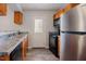Galley-style kitchen featuring stainless steel appliances and laminate flooring at 2032 Lime St, Durham, NC 27704