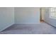 Carpeted living room featuring light grey walls and trim at 2032 Lime St, Durham, NC 27704