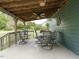 Back deck with seating for six people and an outdoor ceiling fan at 204 Wiley Oaks Dr, Wendell, NC 27591