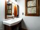 Charming bathroom with vanity, framed mirror, and a window with decorative floral film at 204 Wiley Oaks Dr, Wendell, NC 27591