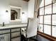 Bathroom vanity with granite countertop, a white-framed mirror, and natural light from the window at 204 Wiley Oaks Dr, Wendell, NC 27591