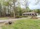 Charming home with a welcoming front porch and picturesque landscaping, surrounded by mature trees at 204 Wiley Oaks Dr, Wendell, NC 27591