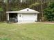 Charming white outbuilding offers additional storage or workshop space with a yard at 204 Wiley Oaks Dr, Wendell, NC 27591