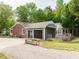 Charming home exterior with brick accents, landscaping and an attached garage at 204 Wiley Oaks Dr, Wendell, NC 27591