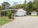 This white detached garage has an awning and a two-car garage for extra storage at 204 Wiley Oaks Dr, Wendell, NC 27591