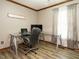 Home office with glass top desk, ergonomic chair, and natural light from the window at 204 Wiley Oaks Dr, Wendell, NC 27591