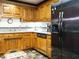 Spacious kitchen features oak cabinets and stainless steel refrigerator at 204 Wiley Oaks Dr, Wendell, NC 27591