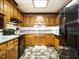 Full kitchen view of oak cabinets, stainless appliances and checkered flooring at 204 Wiley Oaks Dr, Wendell, NC 27591