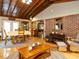 Open living area featuring a brick accent wall, hardwood floors and ample seating at 204 Wiley Oaks Dr, Wendell, NC 27591