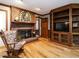 Living room with fireplace, built-in shelving, hardwood floors, and rocking chair at 204 Wiley Oaks Dr, Wendell, NC 27591