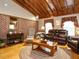 Cozy living room with hardwood floors, brick accent wall, and traditional furnishings at 204 Wiley Oaks Dr, Wendell, NC 27591
