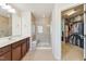 Bathroom featuring a walk-in shower with a glass door and a double vanity with a walk-in closet at 205 Begen St, Morrisville, NC 27560