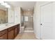 Bathroom featuring a walk-in shower with a glass door and a double vanity at 205 Begen St, Morrisville, NC 27560
