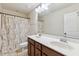 Bathroom with a double sink vanity, a large mirror, and a shower with patterned shower curtain at 205 Begen St, Morrisville, NC 27560