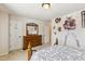 Bedroom with a queen bed, dresser, sports decorations on the wall, and access to a closet at 205 Begen St, Morrisville, NC 27560