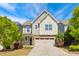 Charming two-story home featuring a two-car garage, neutral siding, and a well-manicured lawn with landscaping at 205 Begen St, Morrisville, NC 27560