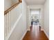 Inviting hallway with hardwood floors, white trim, and a glimpse into a sunlit living space at 205 Begen St, Morrisville, NC 27560