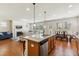Open kitchen layout with island, granite countertops, seamlessly connects to the living and dining spaces at 205 Begen St, Morrisville, NC 27560