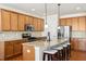 Modern kitchen boasts granite countertops, stainless appliances, a large island, and ample wood cabinetry at 205 Begen St, Morrisville, NC 27560