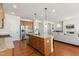 Kitchen features an island with bar seating, stainless appliances, and connects to the living area at 205 Begen St, Morrisville, NC 27560