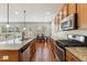 Gourmet kitchen features granite counters, stainless appliances, and opens to living and dining areas at 205 Begen St, Morrisville, NC 27560
