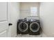 Laundry room with a side-by-side washer and dryer set and overhead shelving with a door at 205 Begen St, Morrisville, NC 27560