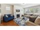 Comfortable living room featuring a fireplace, stylish decor, and large windows at 205 Begen St, Morrisville, NC 27560