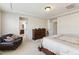 Bright main bedroom with decorative, dark wood furnishings, seating, and neutral-colored walls and carpet at 205 Begen St, Morrisville, NC 27560