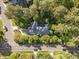Aerial view of a wooded property featuring a house, driveway, and surrounding trees at 2123 Fountain Ridge Rd, Chapel Hill, NC 27517