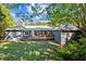 Scenic backyard with a well-maintained lawn, a cozy deck, and beautiful architectural details, perfect for outdoor enjoyment at 2123 Fountain Ridge Rd, Chapel Hill, NC 27517