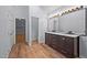 Well-lit bathroom featuring a double vanity with dark cabinets and modern fixtures at 2123 Fountain Ridge Rd, Chapel Hill, NC 27517