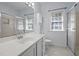 Well-lit bathroom with a single sink vanity, shower, toilet, and window, offering a clean and functional space at 2123 Fountain Ridge Rd, Chapel Hill, NC 27517