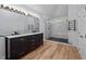 Bright bathroom featuring a marble-top double vanity and a glass-enclosed shower at 2123 Fountain Ridge Rd, Chapel Hill, NC 27517