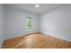 Bright bedroom with hardwood floors, ceiling fan, and a large window offering natural light at 2123 Fountain Ridge Rd, Chapel Hill, NC 27517