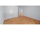 Bedroom featuring hardwood floors, closet, and an open doorway leading to another room, offering potential and charm at 2123 Fountain Ridge Rd, Chapel Hill, NC 27517