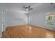 Spacious bedroom with hardwood flooring and a ceiling fan offers comfort and style at 2123 Fountain Ridge Rd, Chapel Hill, NC 27517